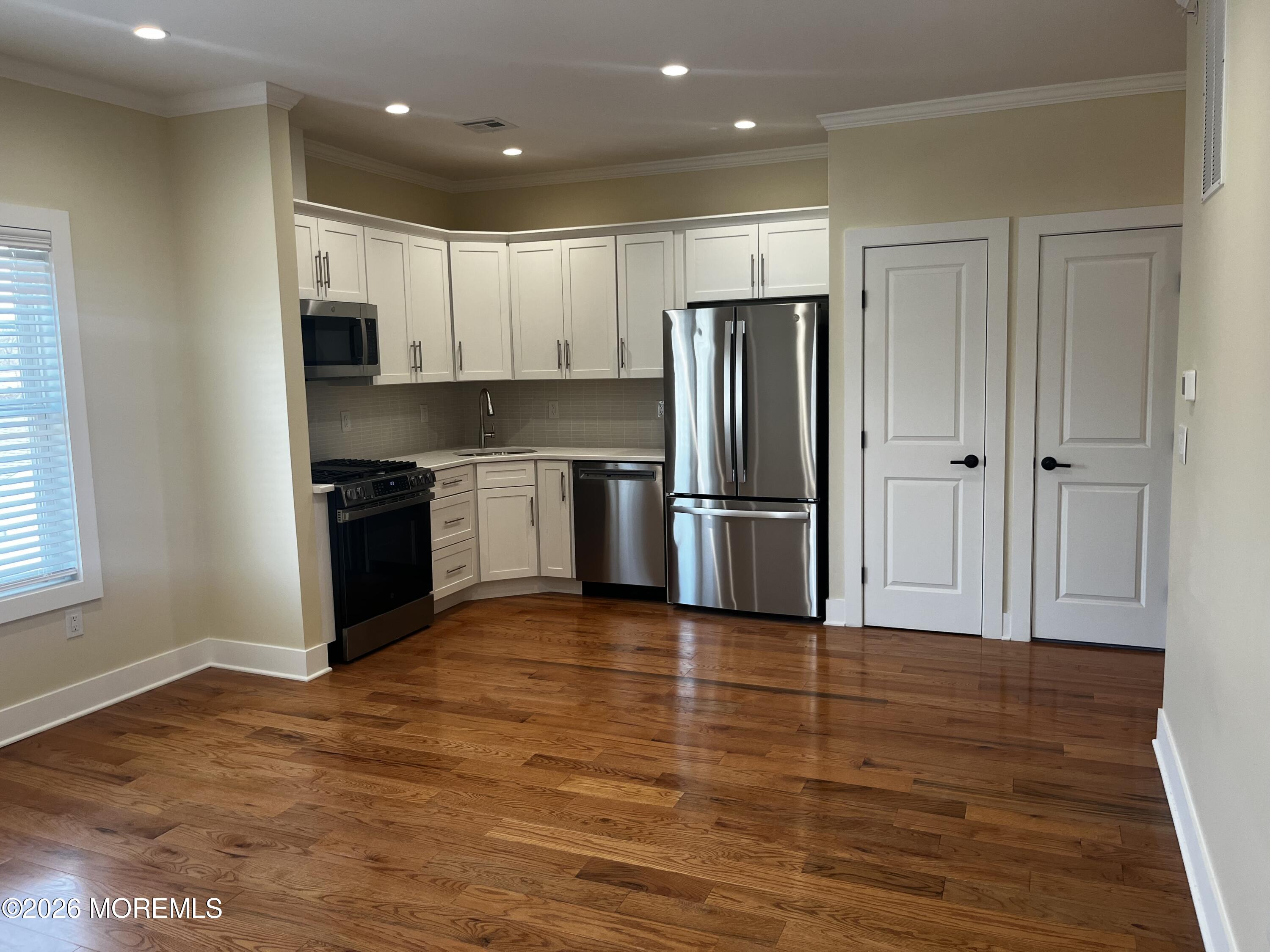 a kitchen with stainless steel appliances granite countertop a refrigerator and a stove top oven