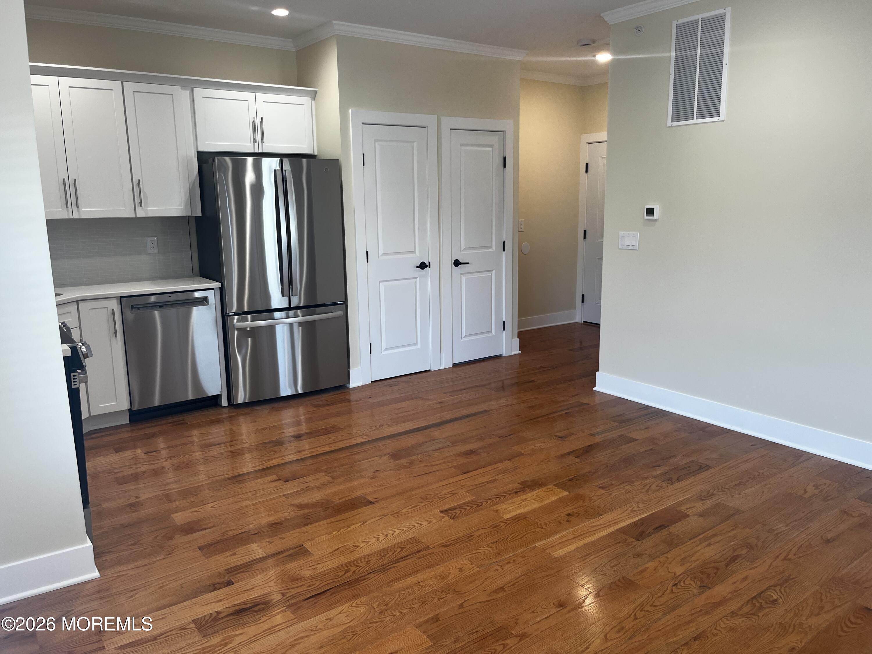 2419 Bridge Avenue, Unit 201 Point Pleasant, NJ 08742 - Photo 2 of 7 a view of a kitchen with wooden floor electronic appliances and cabinets