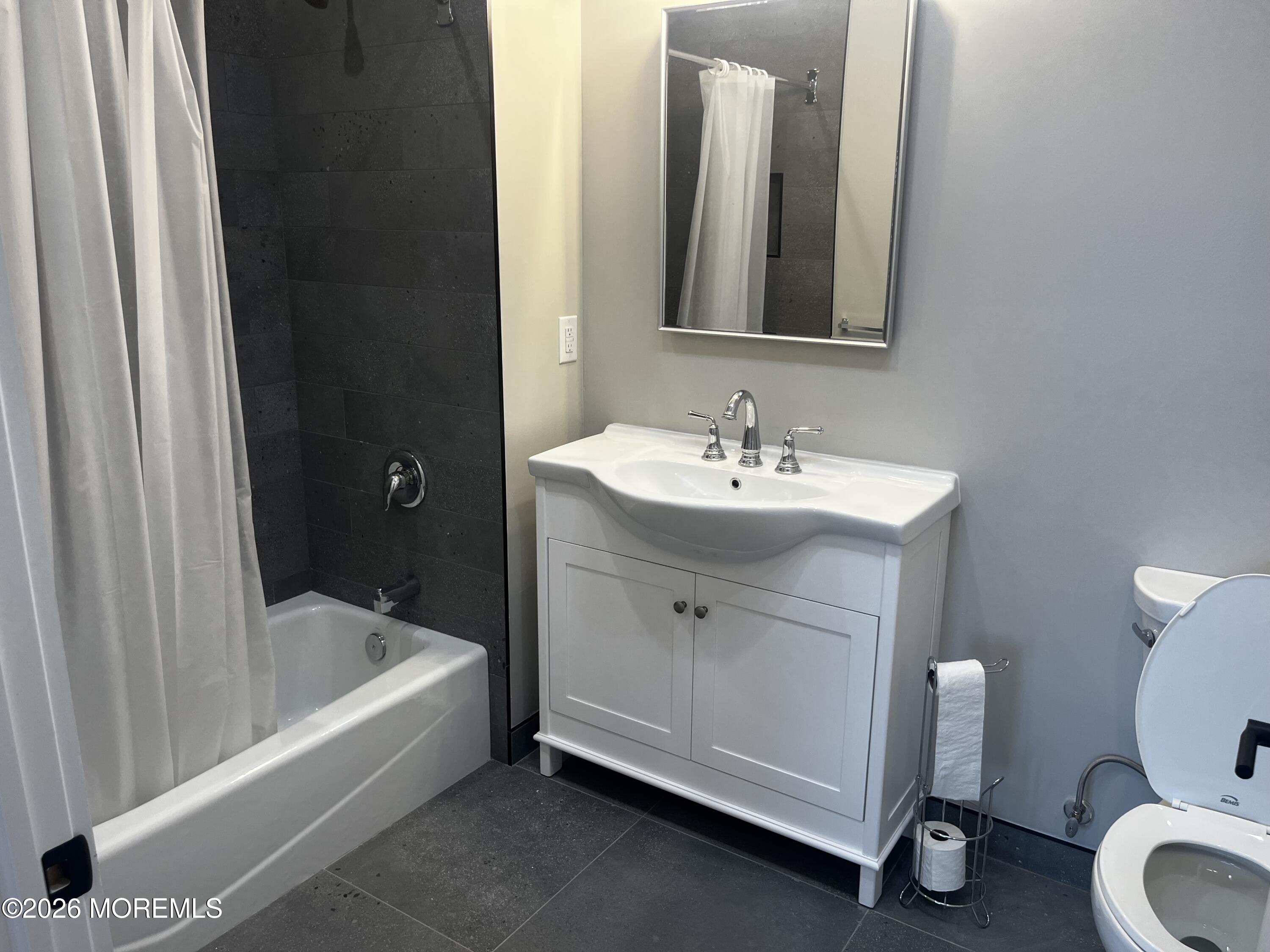 2419 Bridge Avenue, Unit 201 Point Pleasant, NJ 08742 - Photo 3 of 7 a bathroom with a sink a toilet and bathtub