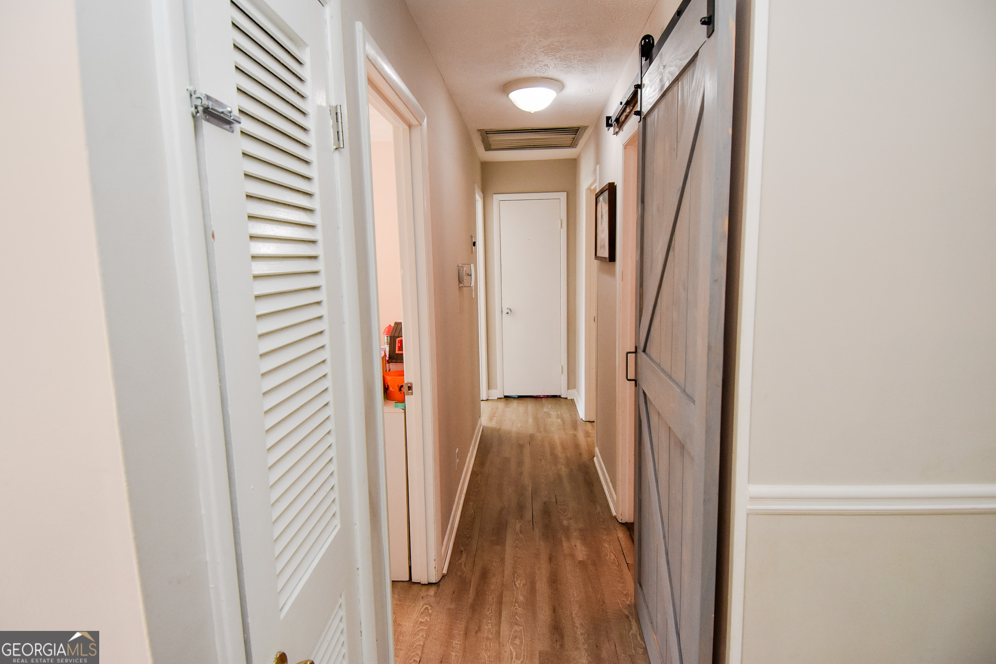 2250 Green Street Concord, GA 30206 - Photo 14 of 77 a view of a hallway with wooden floor and staircase
