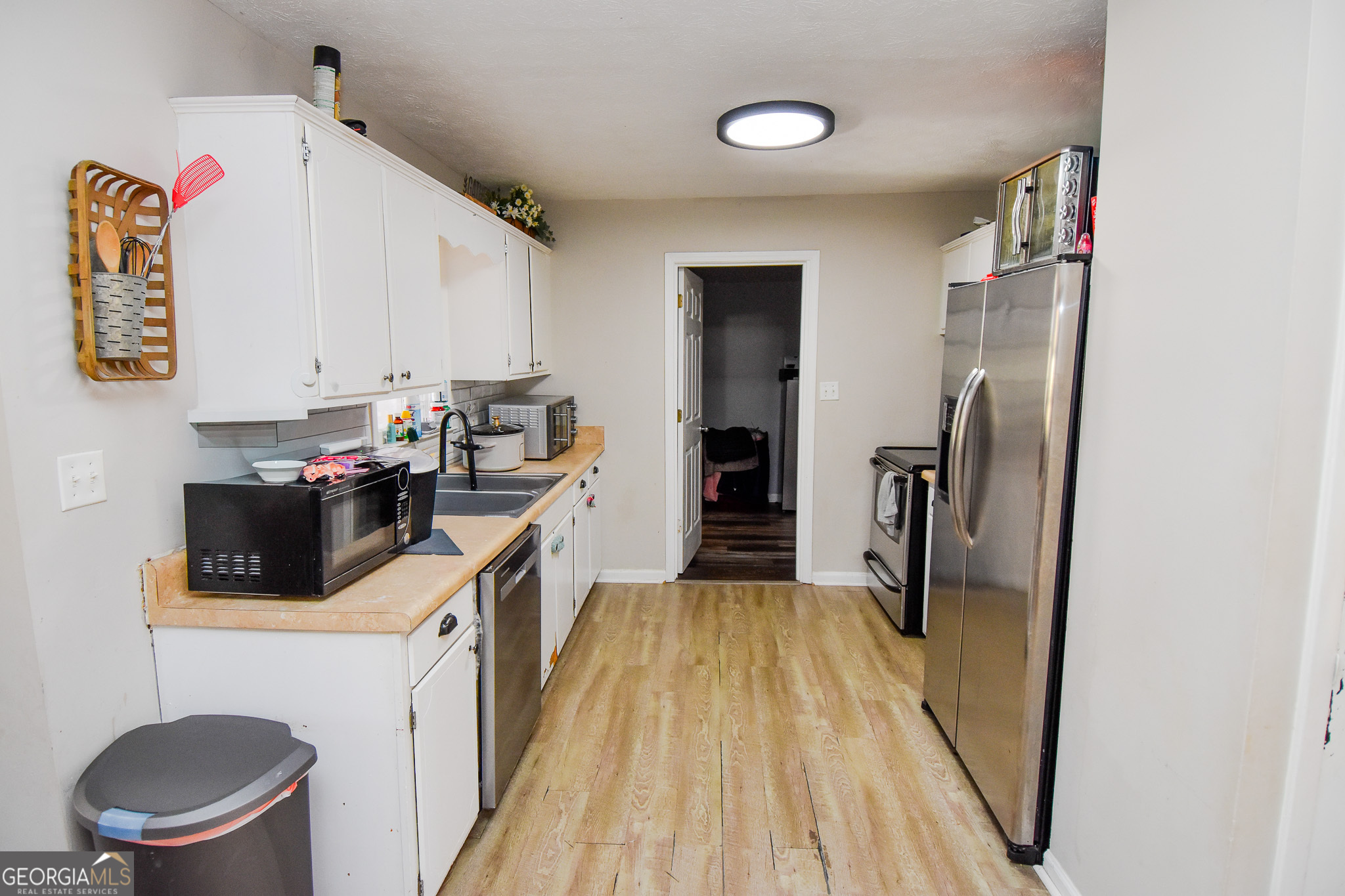 2250 Green Street Concord, GA 30206 - Photo 16 of 77 a kitchen with a refrigerator sink and wooden floor