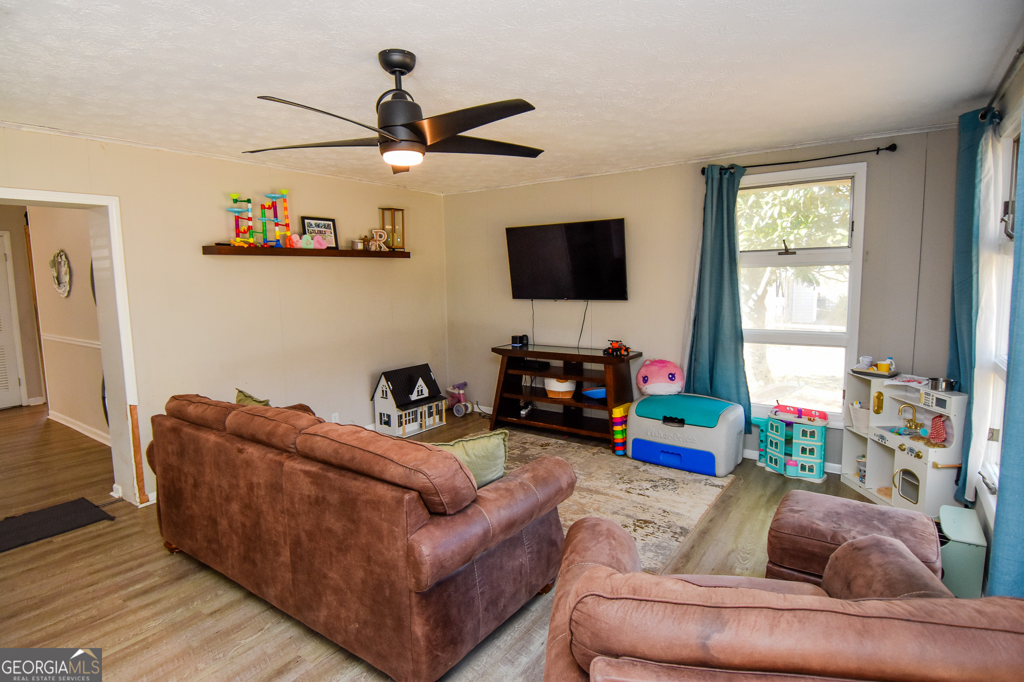2250 Green Street Concord, GA 30206 - Photo 22 of 77 a living room with furniture and a flat screen tv
