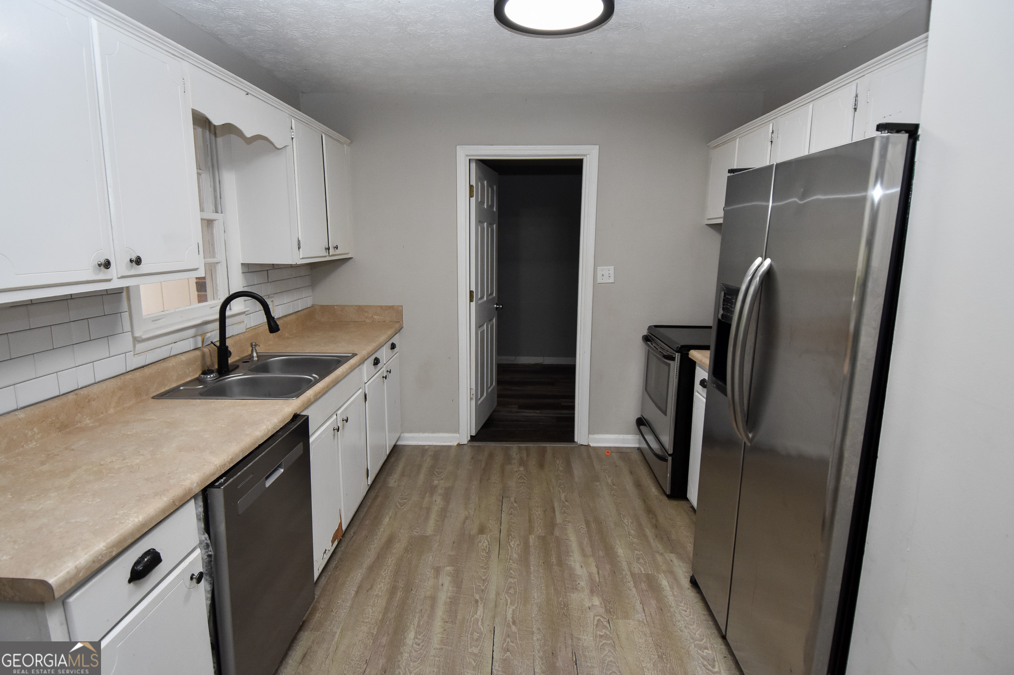 2250 Green Street Concord, GA 30206 - Photo 38 of 77 a kitchen with a sink appliances and cabinets