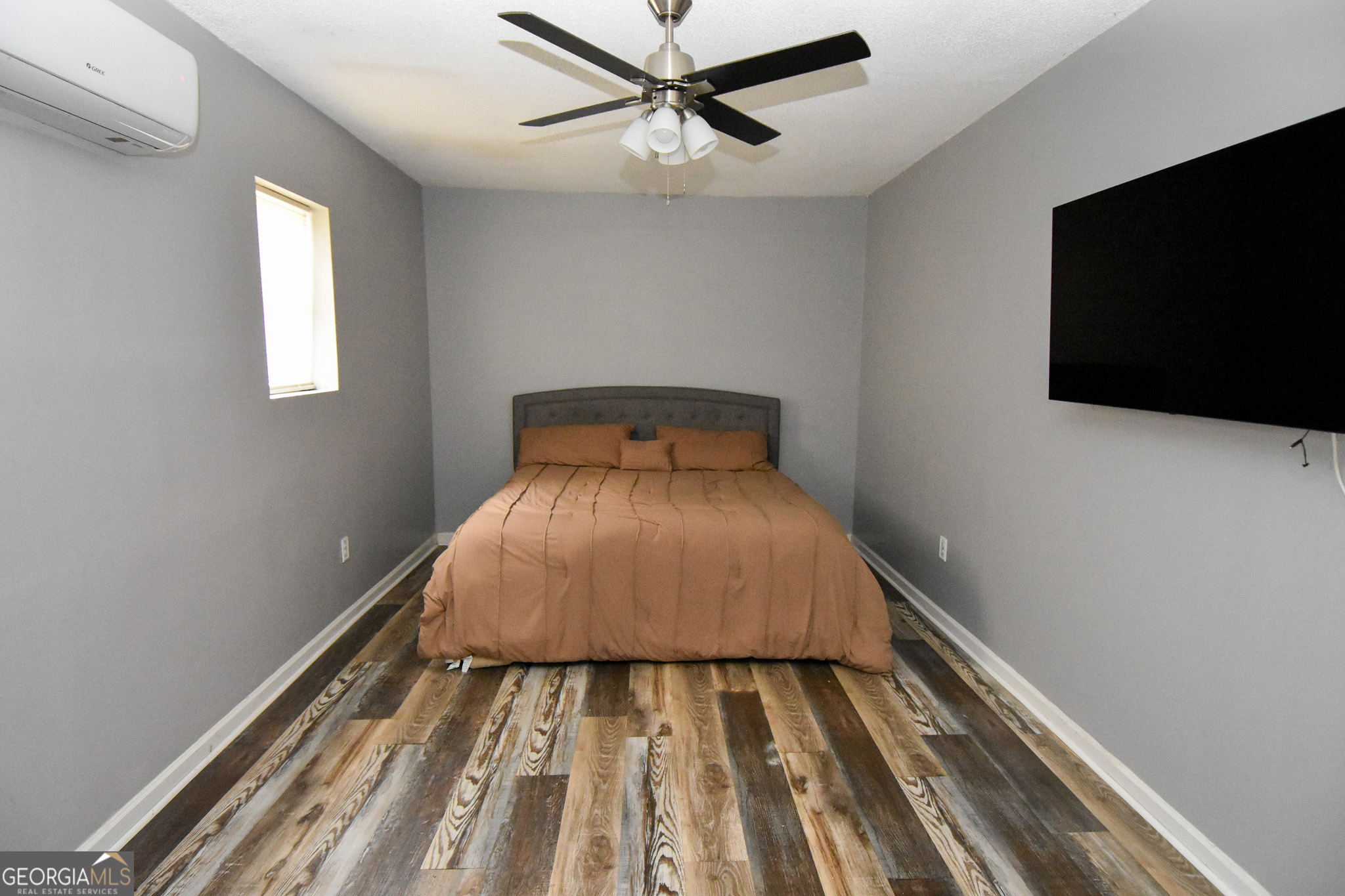 2250 Green Street Concord, GA 30206 - Photo 50 of 77 a bedroom with a bed and a flat tv screen