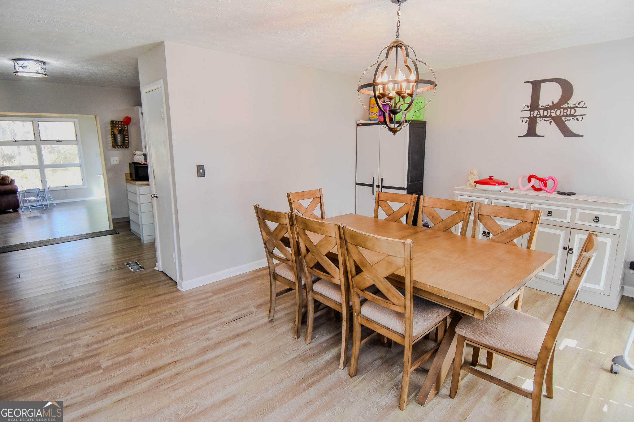 2250 Green Street Concord, GA 30206 - Photo 10 of 77 a dining room with furniture wooden floor and a chandelier