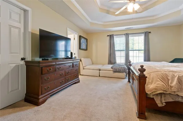 a bedroom with furniture and a flat screen tv