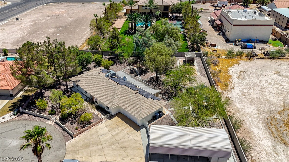 7631 Bermuda Road Las Vegas, NV 89123 - Photo 52 of 64 An aerial perspective showcases a vast property featuring solar panels, lush landscaping, and mature trees.