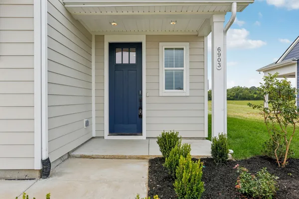 a view of front door of house and yard