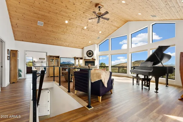 a living room with furniture a wooden floor and chandelier