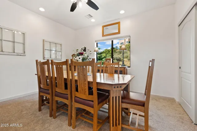 a view of a dining room with furniture and a potted plant