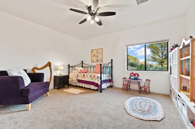 a living room with furniture a rug and a large window