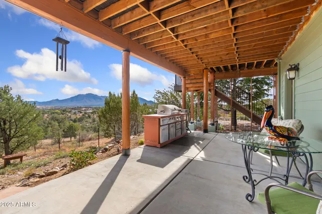 a patio with glass top table and chairs