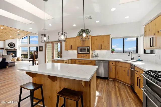 a large kitchen with lots of counter space and sink