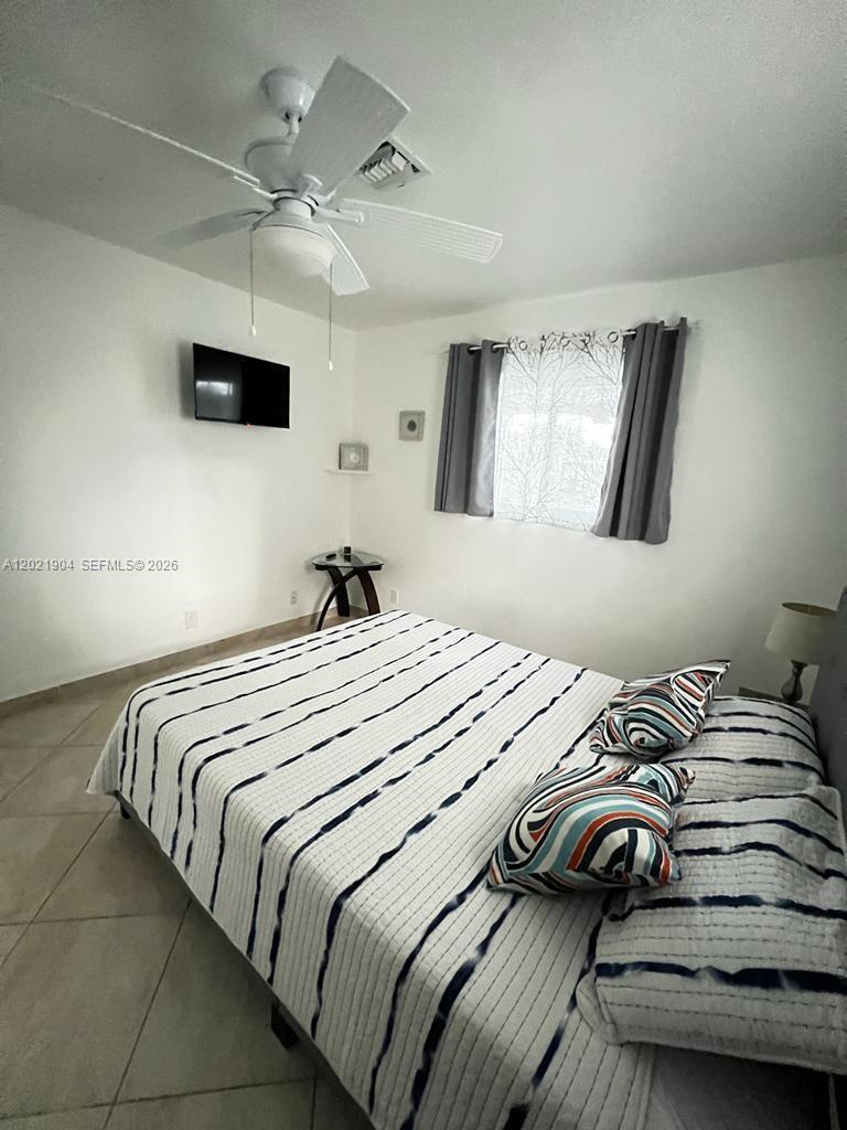 3324 Lakeview Boulevard Delray Beach, FL 33445 - Photo 25 of 36 a bedroom with a bed and a flat screen tv