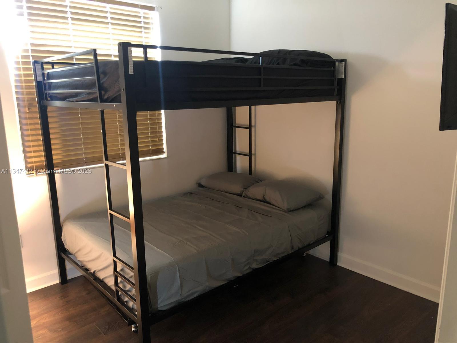 10836 Southwest 245th Street Homestead, FL 33032 - Photo 12 of 18 a bedroom with a bed and a window