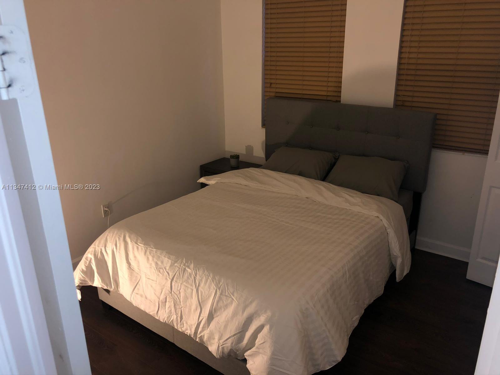 10836 Southwest 245th Street Homestead, FL 33032 - Photo 14 of 18 a bed sitting in a bedroom next to a window