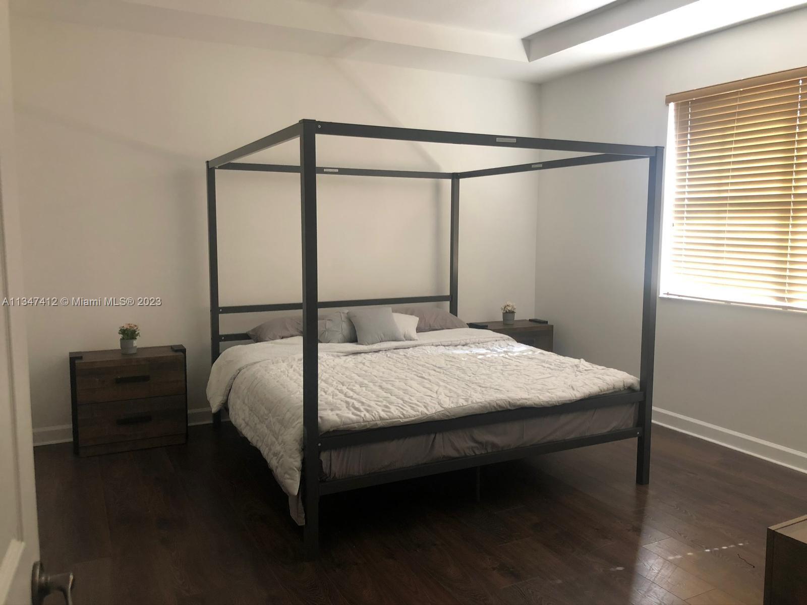 10836 Southwest 245th Street Homestead, FL 33032 - Photo 15 of 18 a bedroom with a bed and window