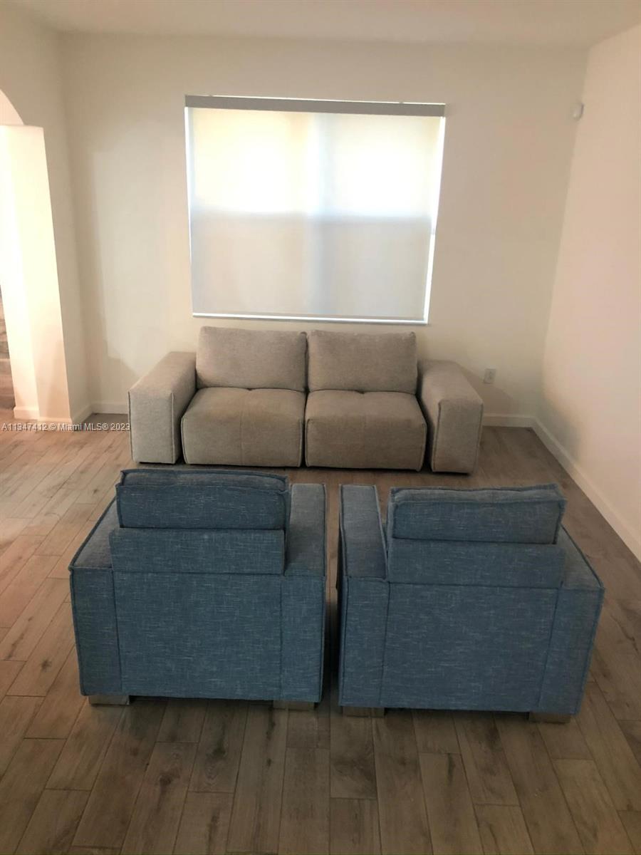 10836 Southwest 245th Street Homestead, FL 33032 - Photo 4 of 18 a living room with furniture and a window