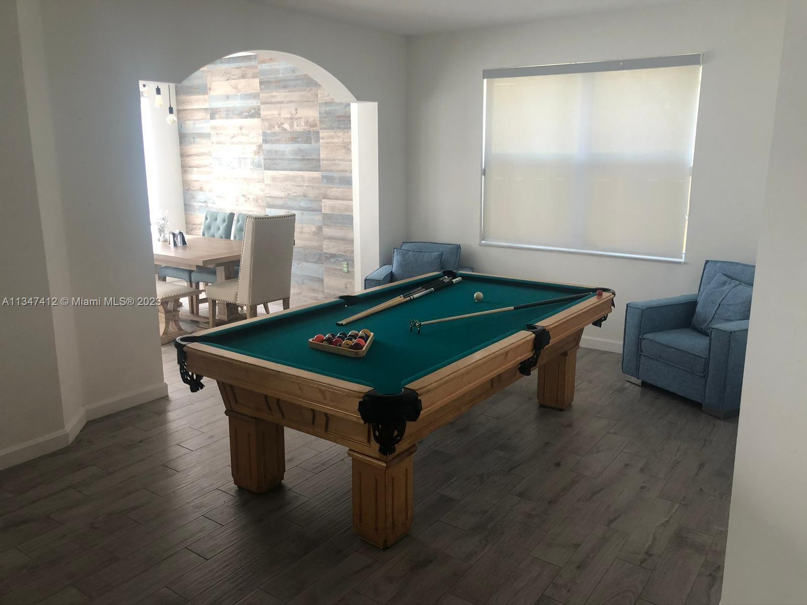 10836 Southwest 245th Street Homestead, FL 33032 - Photo 5 of 18 a room with furniture pool table and windows
