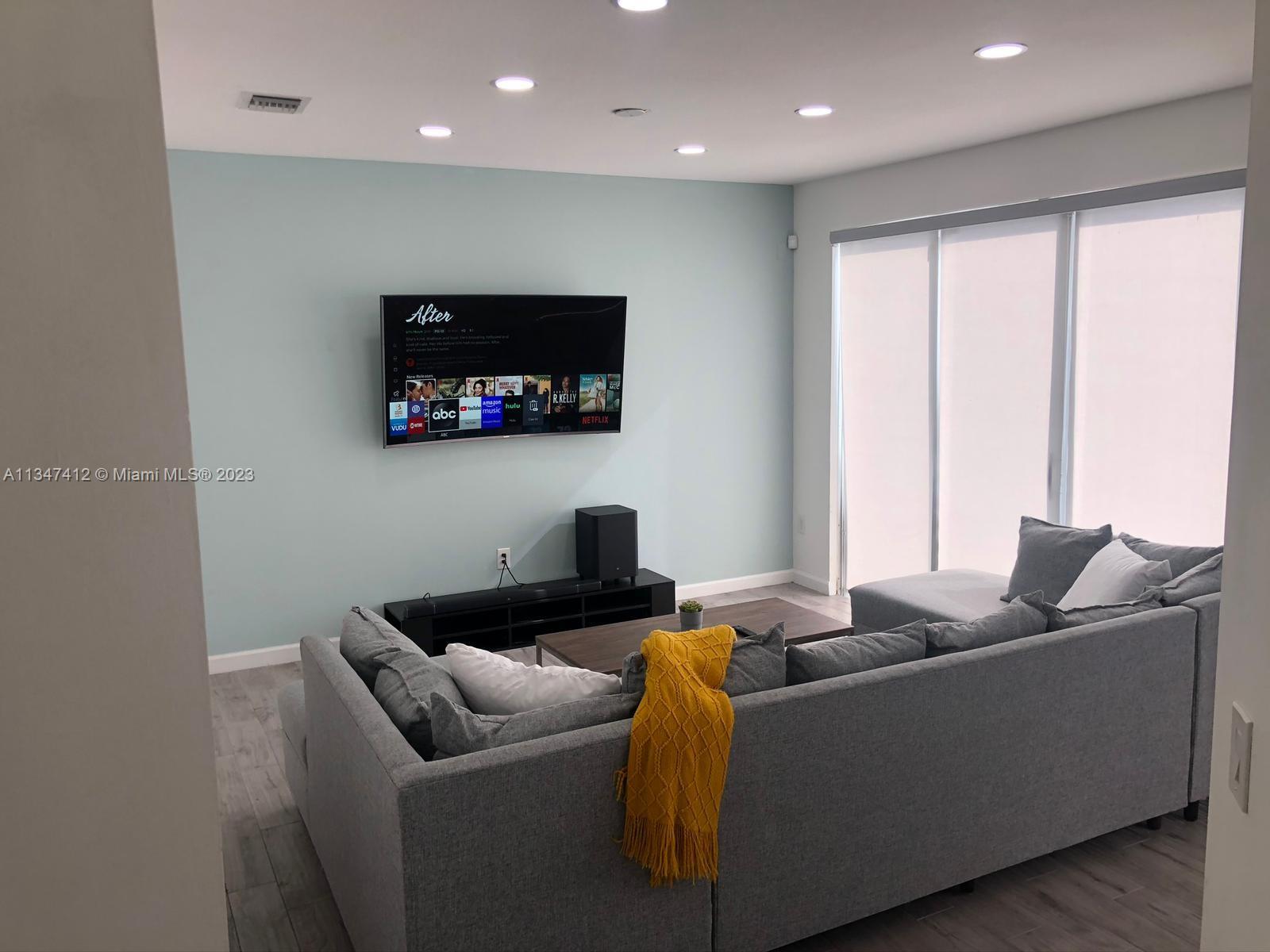 10836 Southwest 245th Street Homestead, FL 33032 - Photo 6 of 18 a living room with furniture and a flat screen tv