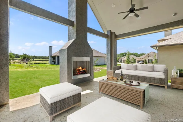 a outdoor space with patio couch and a fireplace
