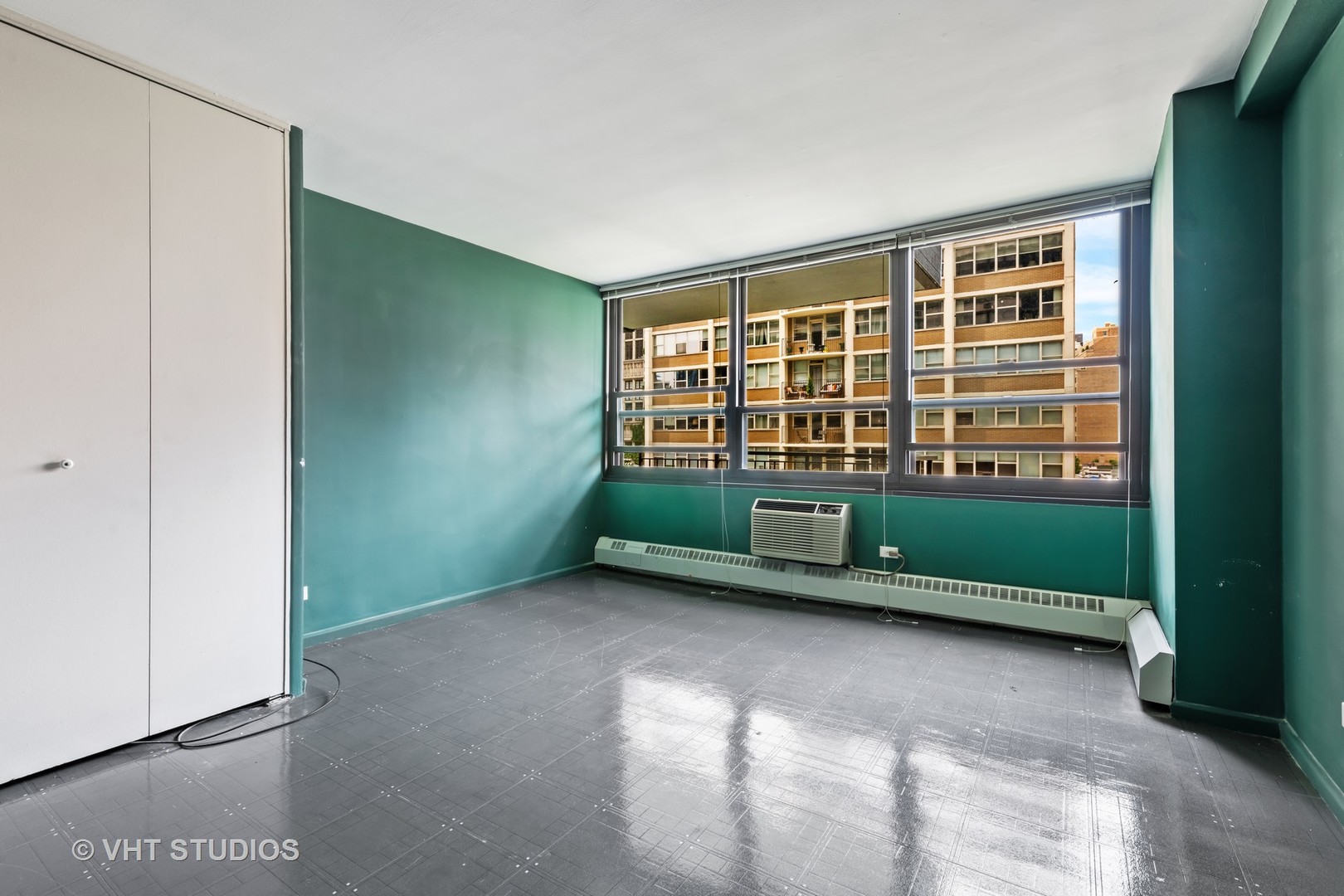 33 East Cedar Street, Unit 8H Chicago, IL 60611 - Photo 11 of 15 a view of an empty room with a window and hardwood