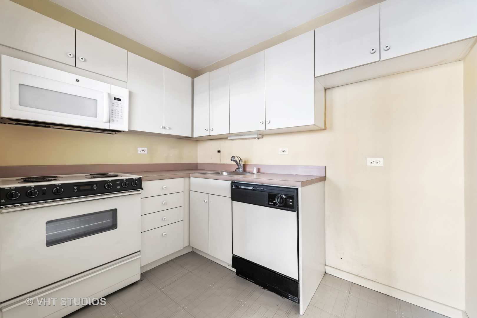 33 East Cedar Street, Unit 8H Chicago, IL 60611 - Photo 8 of 15 a kitchen with white cabinets and white appliances