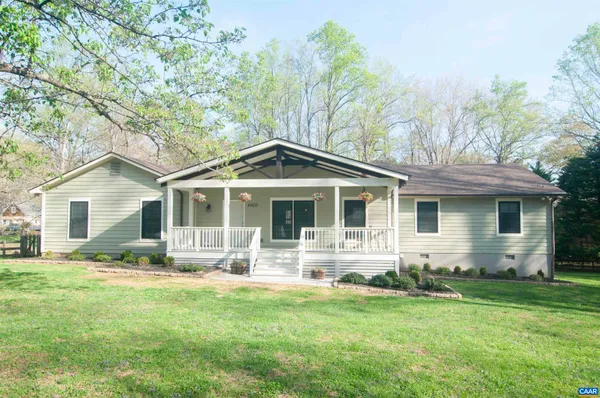 a front view of house with yard and green space