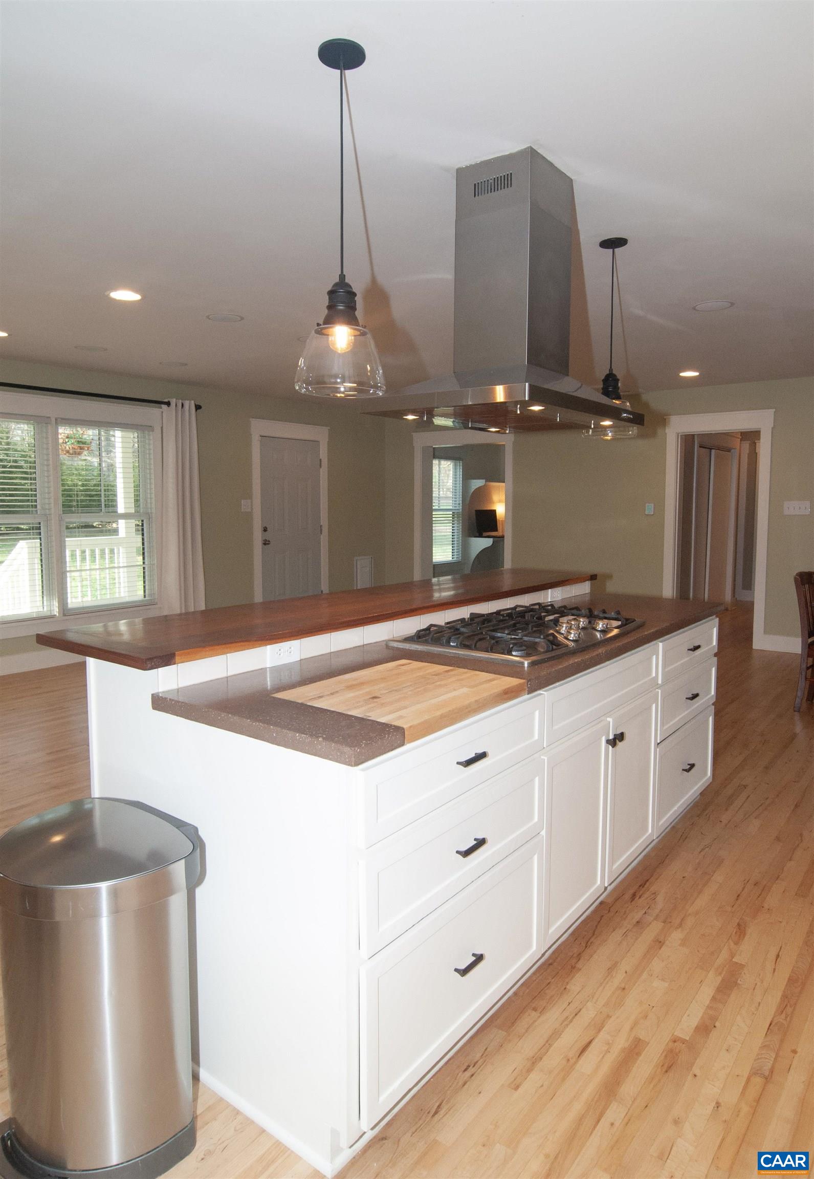 4600 Advance Mills Road Earlysville, VA 22936 - Photo 12 of 61 a kitchen with kitchen island granite countertop a stove and a wooden floors