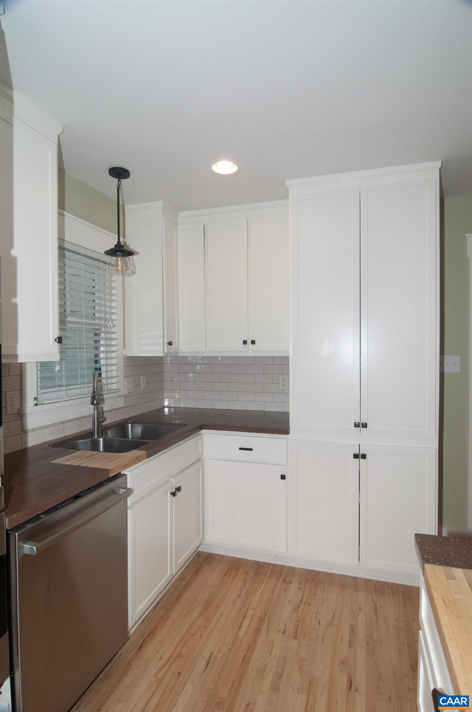 4600 Advance Mills Road Earlysville, VA 22936 - Photo 13 of 61 a kitchen with granite countertop a sink cabinets and wooden floor