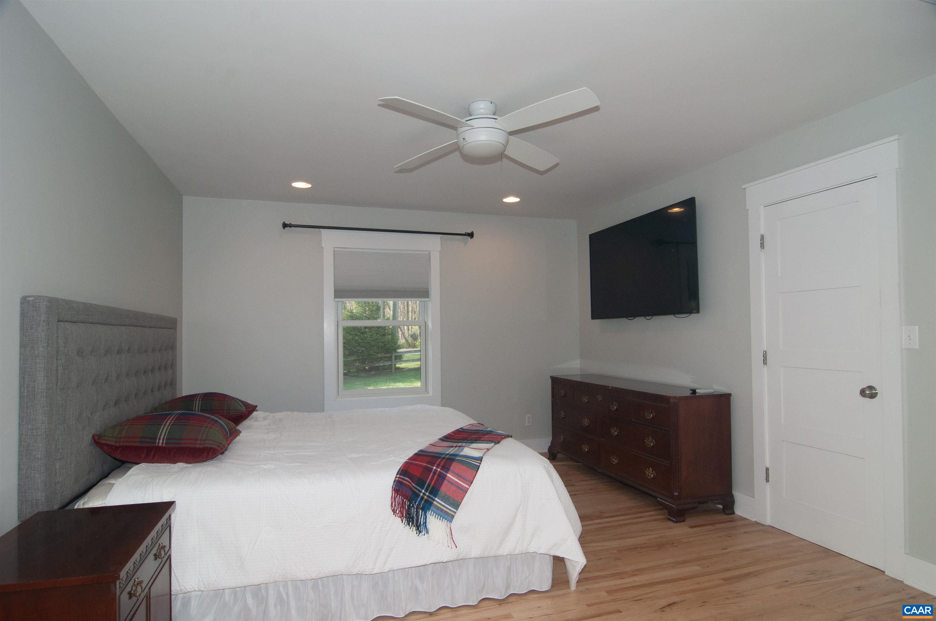 4600 Advance Mills Road Earlysville, VA 22936 - Photo 25 of 61 a bedroom with a bed and a flat screen tv
