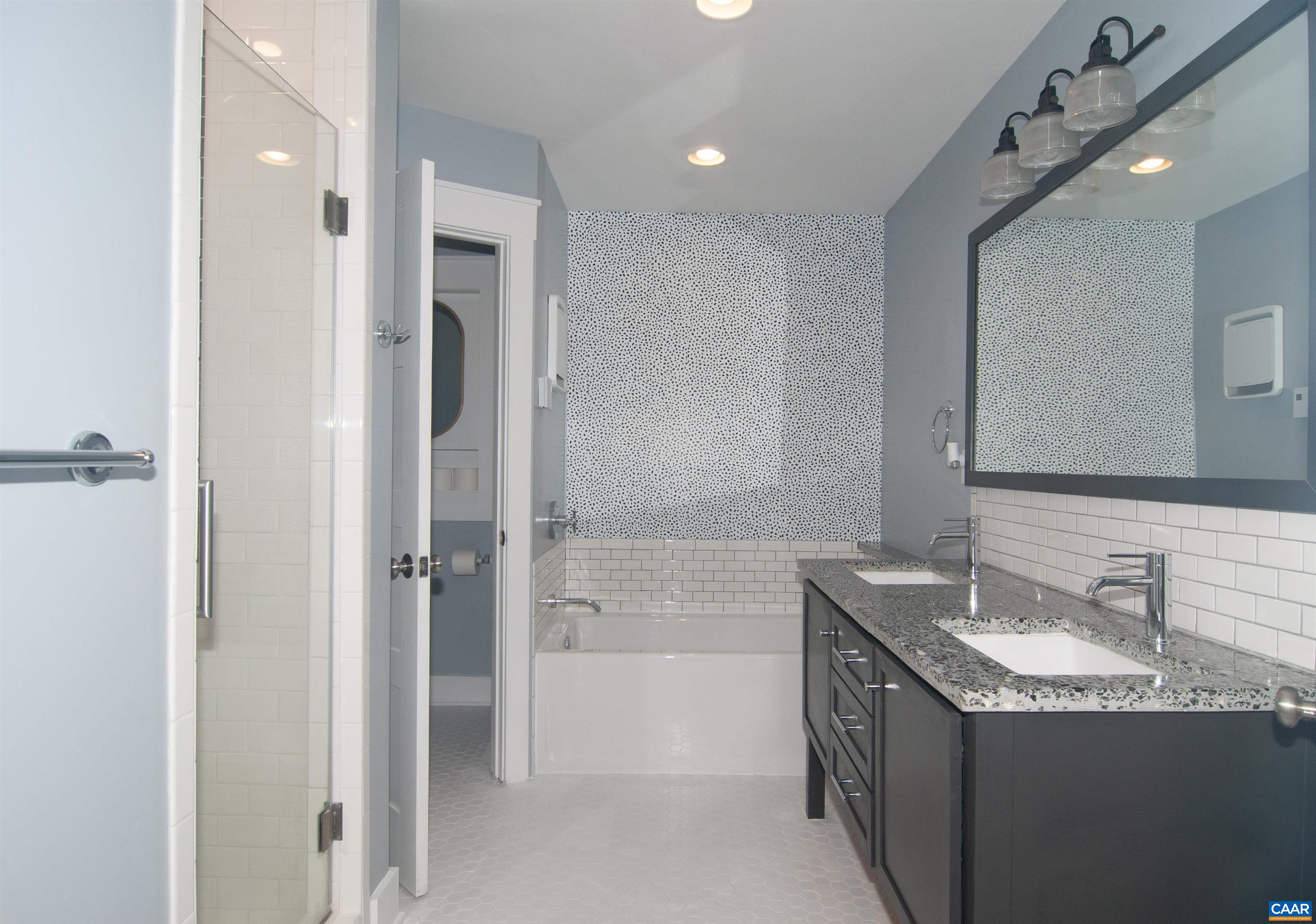 4600 Advance Mills Road Earlysville, VA 22936 - Photo 29 of 61 a bathroom with a granite countertop sink mirror and a bathtub
