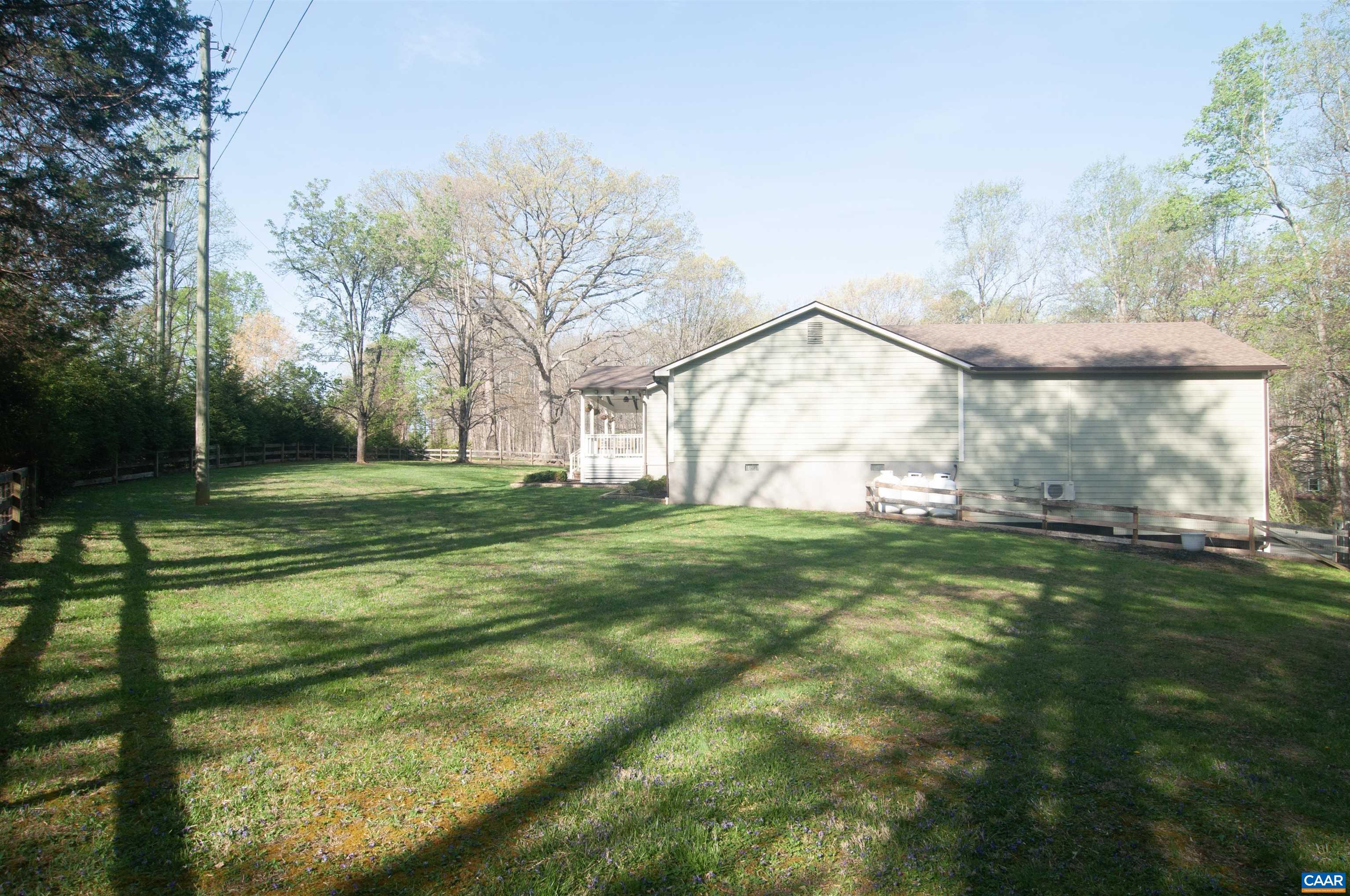 4600 Advance Mills Road Earlysville, VA 22936 - Photo 3 of 61 a view of a white house in a big yard with large trees