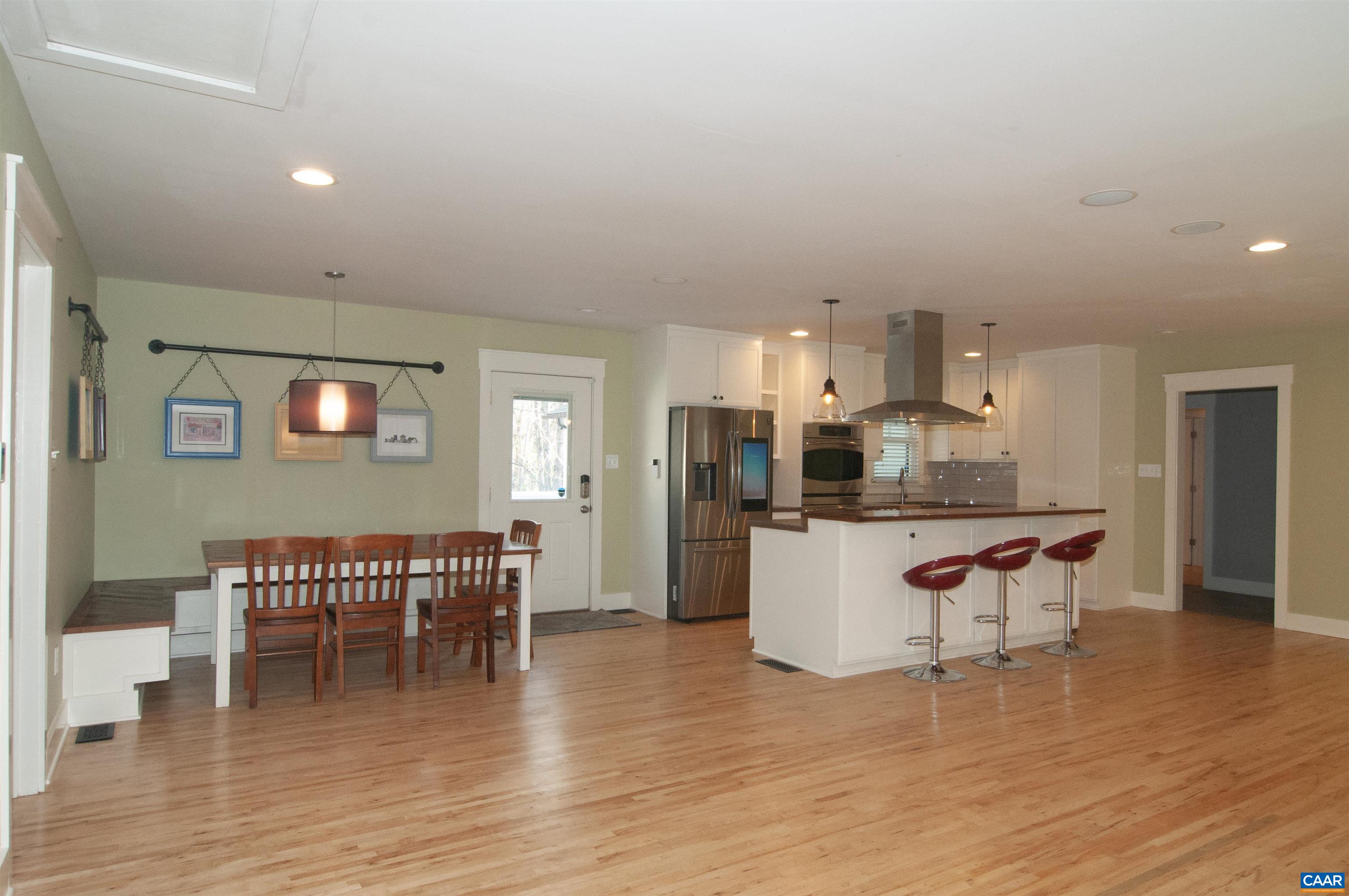4600 Advance Mills Road Earlysville, VA 22936 - Photo 4 of 61 a kitchen with a dining table chairs and white cabinets