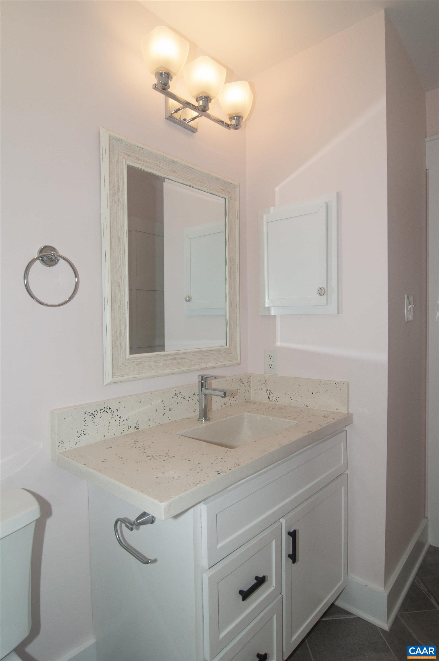 4600 Advance Mills Road Earlysville, VA 22936 - Photo 41 of 61 a bathroom with a granite countertop sink and a mirror