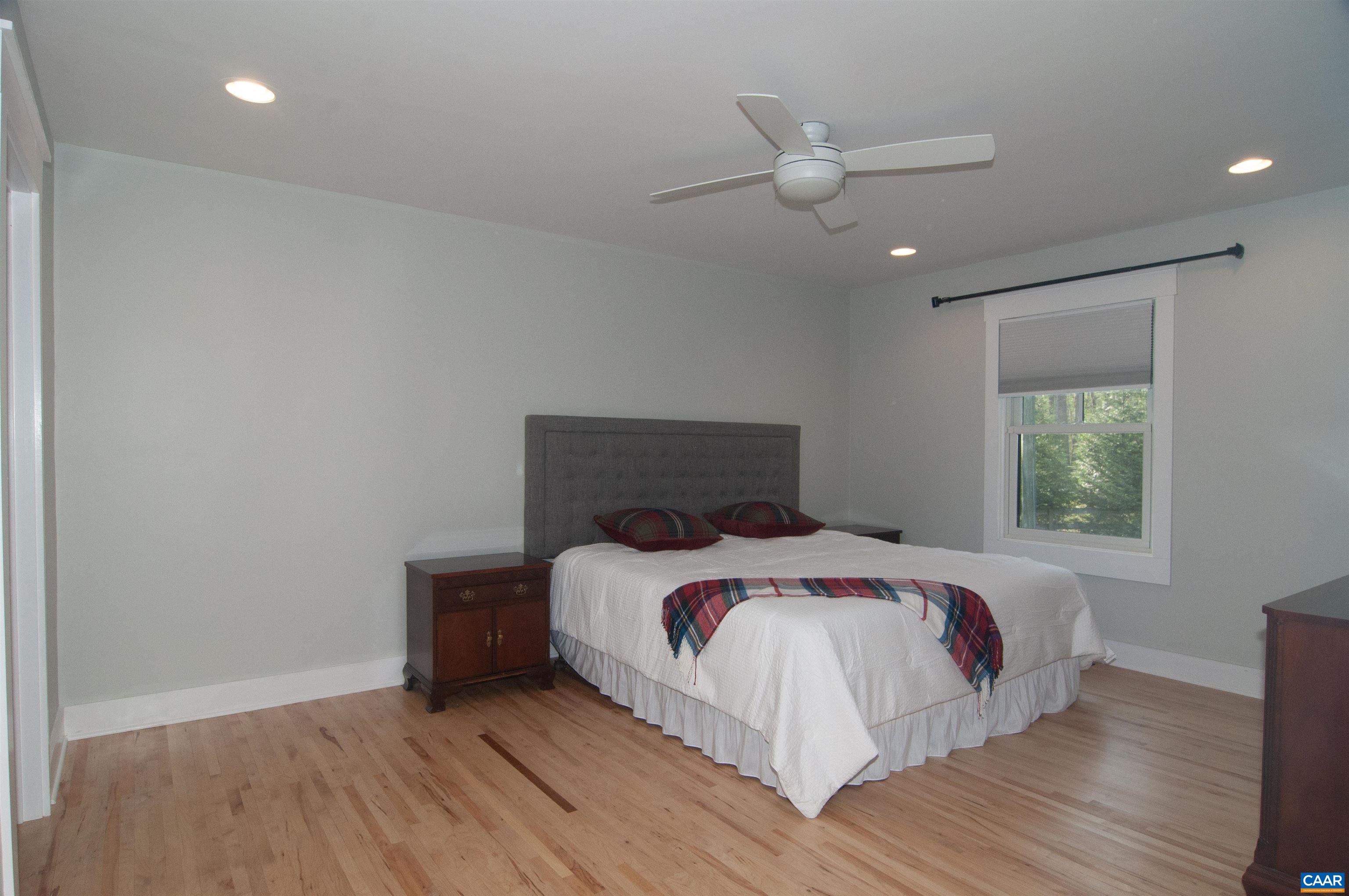 4600 Advance Mills Road Earlysville, VA 22936 - Photo 61 of 61 a bedroom with a bed and a ceiling fan