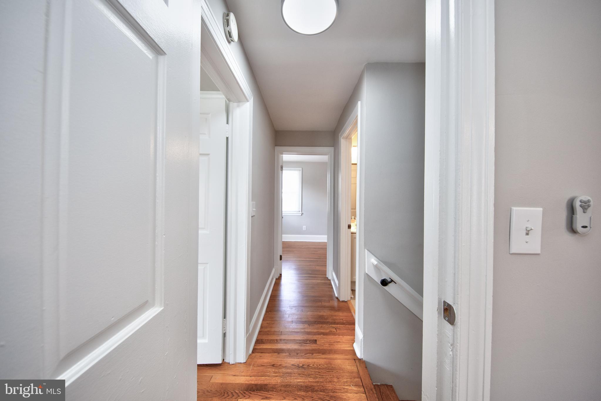 2326 Ivy Avenue Baltimore, MD 21214 - Photo 12 of 30 a view of a hallway with wooden floor and staircase