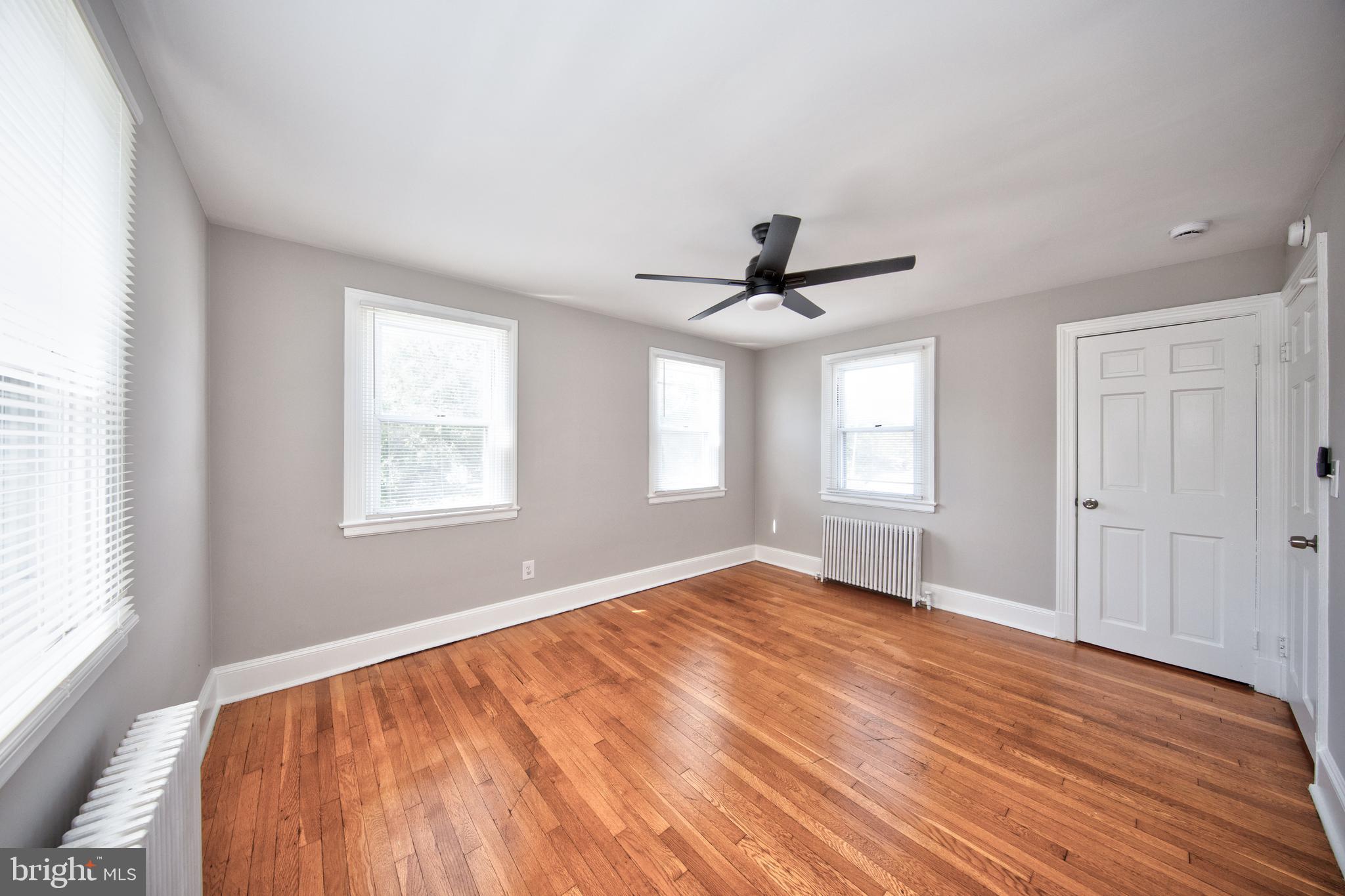 2326 Ivy Avenue Baltimore, MD 21214 - Photo 13 of 30 a view of empty room with wooden floor and fan