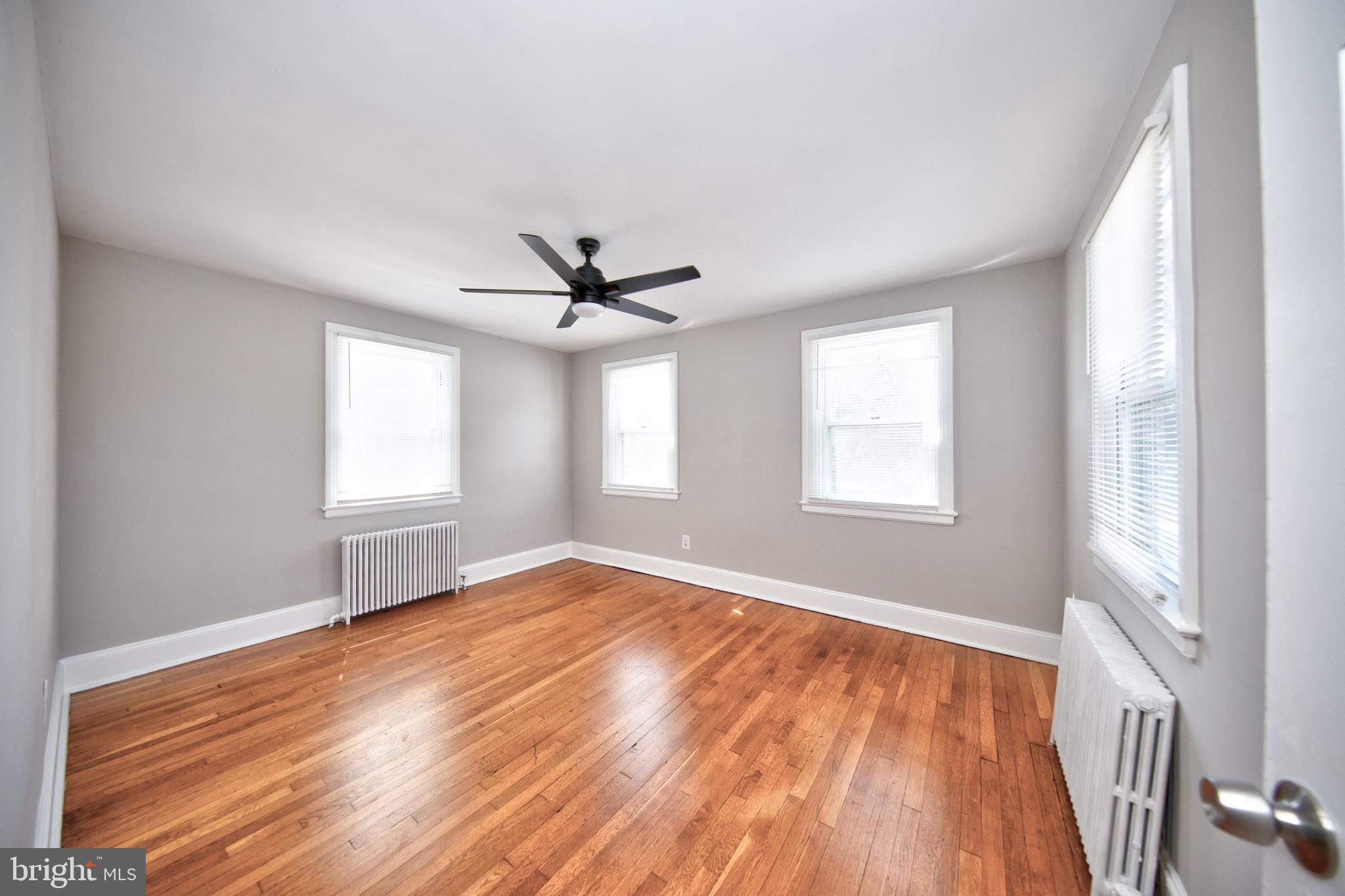 2326 Ivy Avenue Baltimore, MD 21214 - Photo 15 of 30 a view of empty room with wooden floor and fan