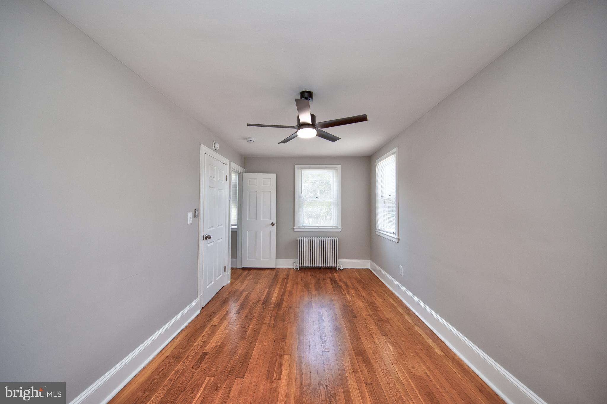 2326 Ivy Avenue Baltimore, MD 21214 - Photo 16 of 30 a view of empty room with wooden floor and fan