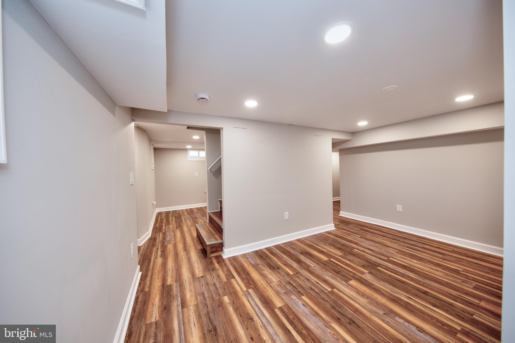 2326 Ivy Avenue Baltimore, MD 21214 - Photo 21 of 30 wooden floor in an empty room with a window