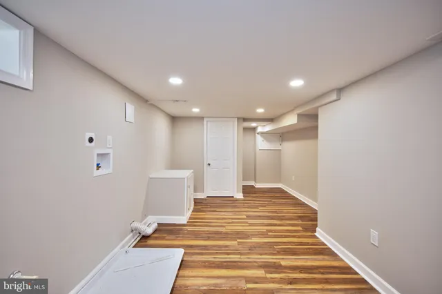 a view of a livingroom with wooden floor and white walls