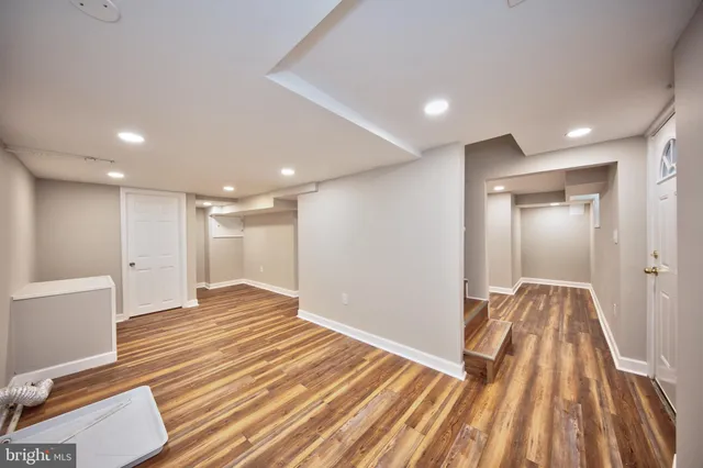 a view of a room with wooden floor and staircase