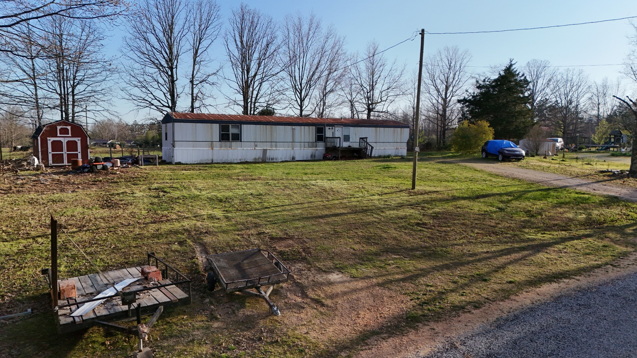 118 Oakwood Road Hohenwald, TN 38462 - Photo 16 of 21 a backyard of a house with lots of green space