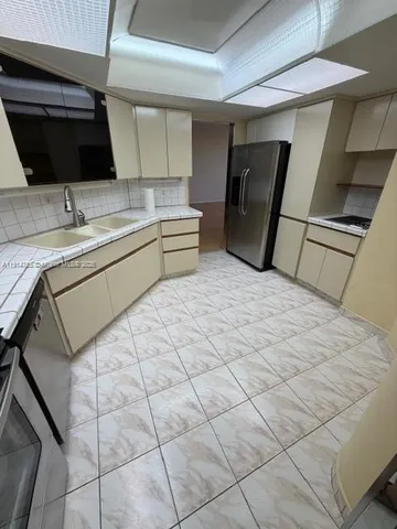 a kitchen with a sink and cabinets