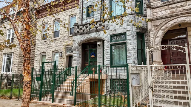 front view of a brick house with a large windows