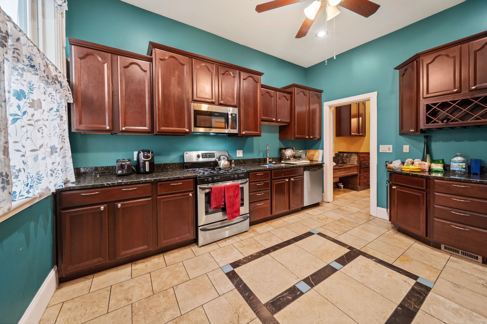 3602 South Prairie Avenue Chicago, IL 60653 - Photo 11 of 34 a kitchen with stainless steel appliances granite countertop a stove sink and cabinets