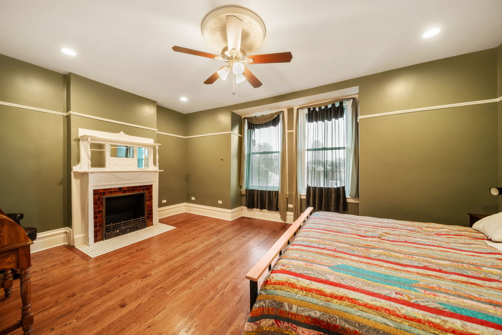 3602 South Prairie Avenue Chicago, IL 60653 - Photo 14 of 34 a bedroom with a bed and a fireplace