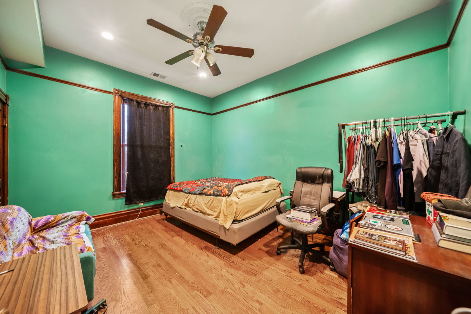 3602 South Prairie Avenue Chicago, IL 60653 - Photo 18 of 34 a bedroom with a bed and a chandelier