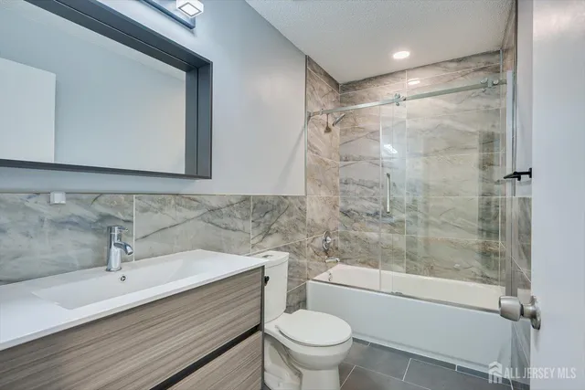 a bathroom with a sink mirror toilet and bathtub